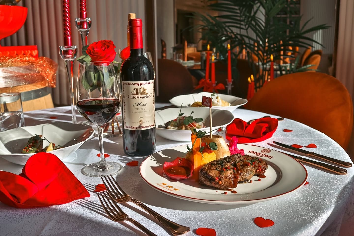 A Choijin Temple table set with steak, red wine, roses and red candles for a Valentine’s promotion.