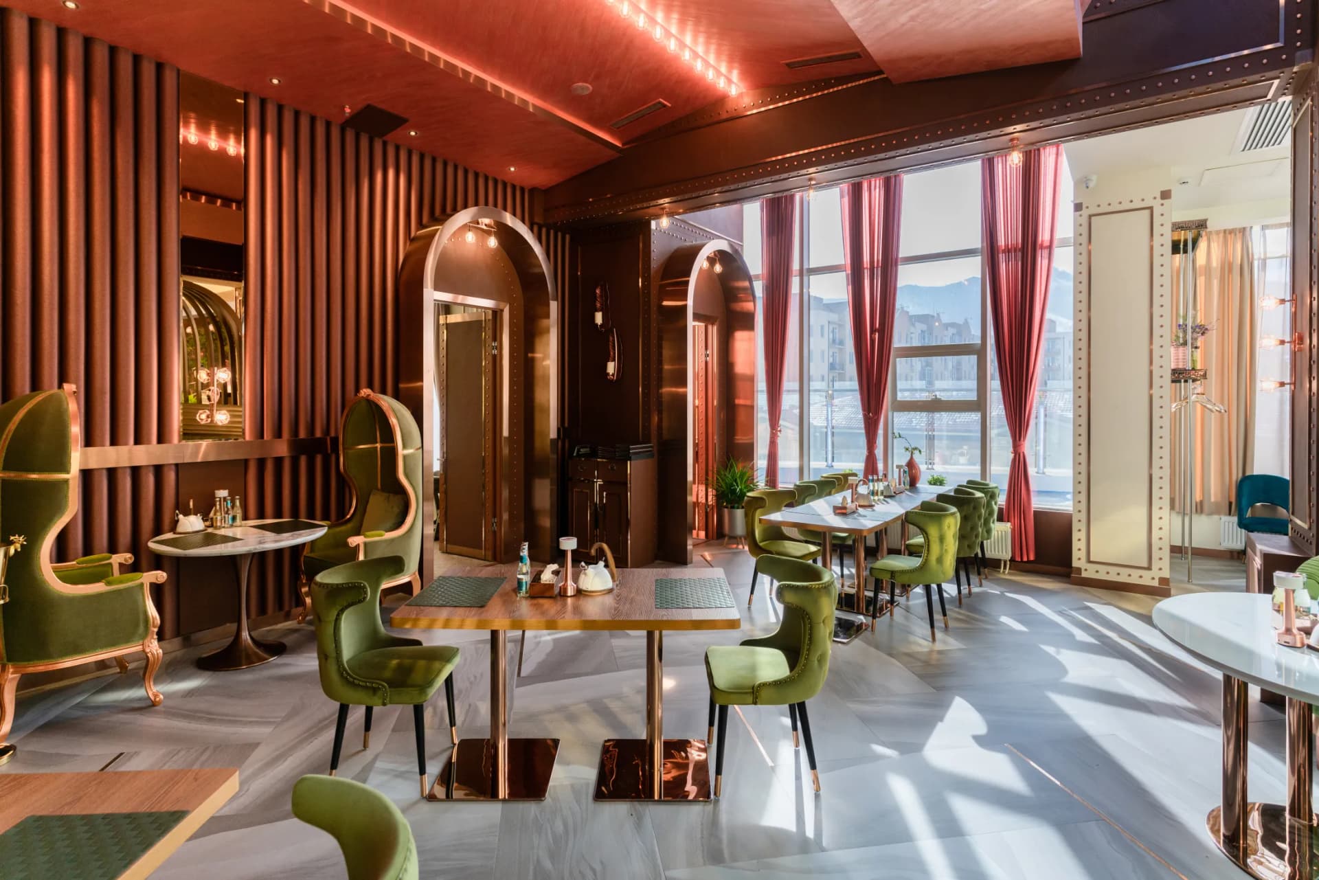 Bright dining room with warm chandeliers and elegant tables.